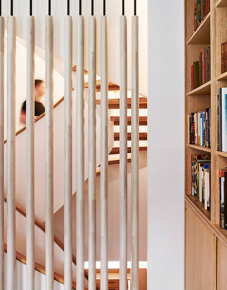 Staircase - huge 1960s wooden curved open and mixed material railing staircase idea in New York