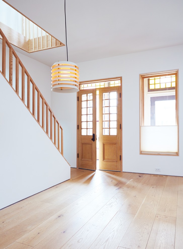 This is an example of a small contemporary wood straight staircase in Toronto with wood risers.