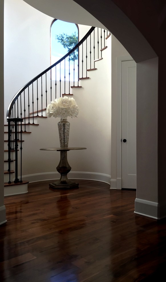 Inspiration for a large mediterranean wooden curved mixed material railing staircase remodel in Tampa with painted risers