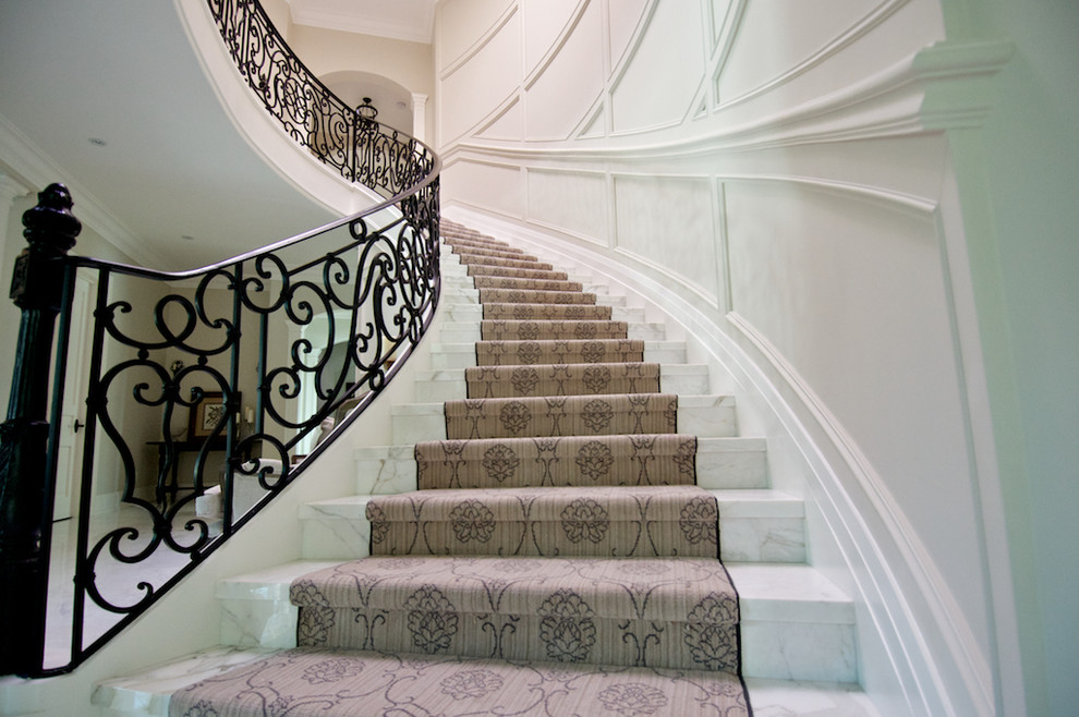 Huge elegant curved staircase photo in Toronto