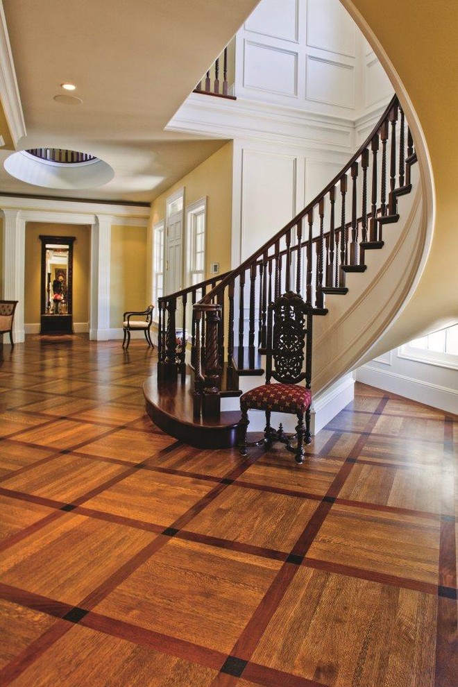 Large mediterranean wood curved staircase in Orange County with wood risers.