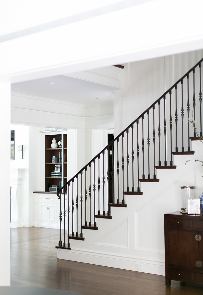 Inspiration for a large transitional wooden straight metal railing staircase remodel in Los Angeles with painted risers