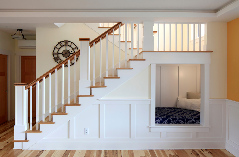 This is an example of a medium sized traditional wood u-shaped wood railing staircase in Other with painted wood risers.