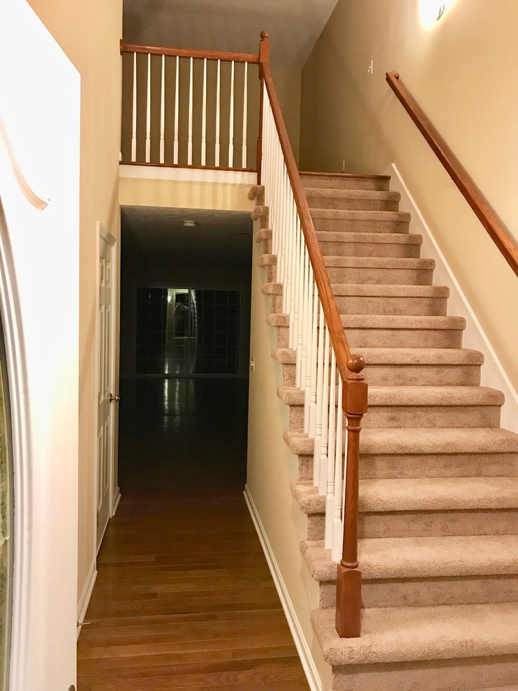 Inspiration for a large timeless carpeted straight wood railing staircase remodel in Boston with carpeted risers