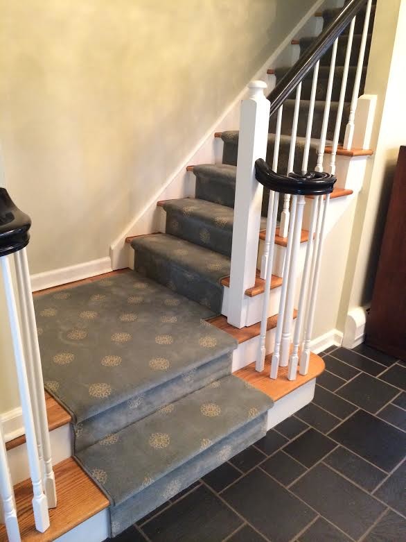 Inspiration for a mid-sized carpeted l-shaped staircase remodel in New York with wooden risers