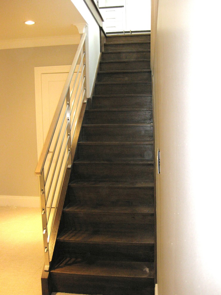 Photo of a large modern wood straight staircase in Chicago with wood risers.