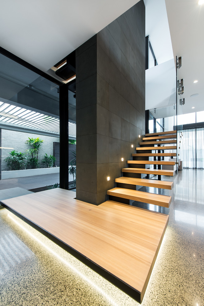 Photo of a contemporary wood l-shaped staircase in Melbourne with open risers.