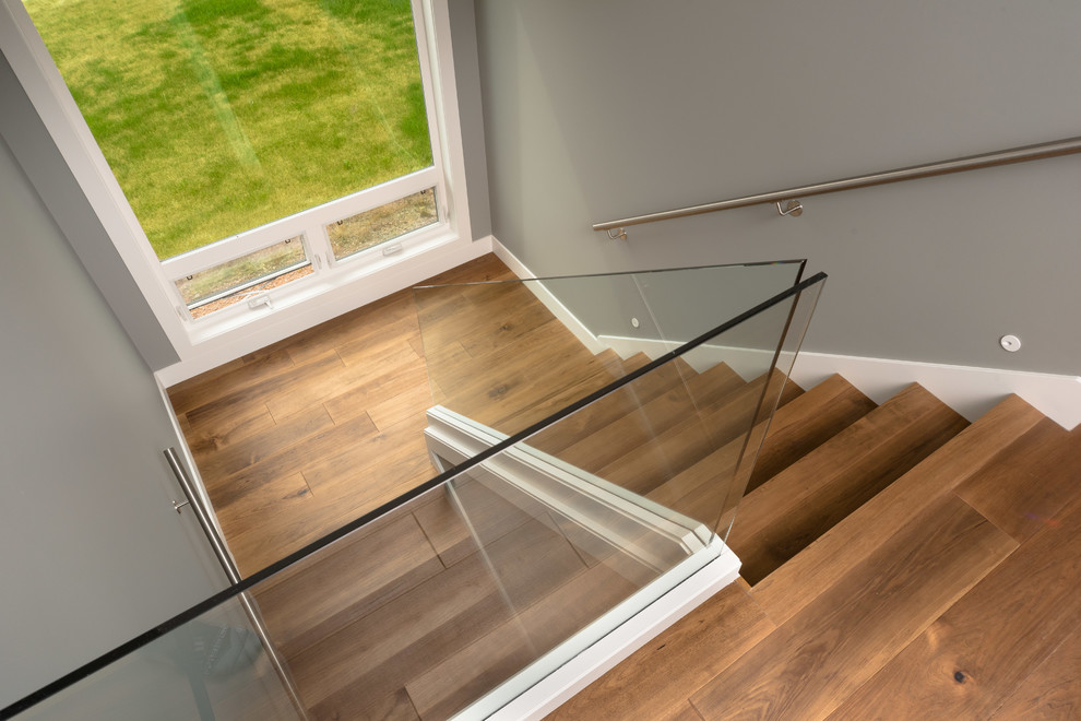 Example of a mid-sized trendy wooden u-shaped glass railing staircase design in Vancouver with wooden risers