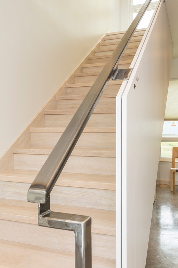 Inspiration for a mid-sized modern wooden straight metal railing staircase remodel in Denver with wooden risers