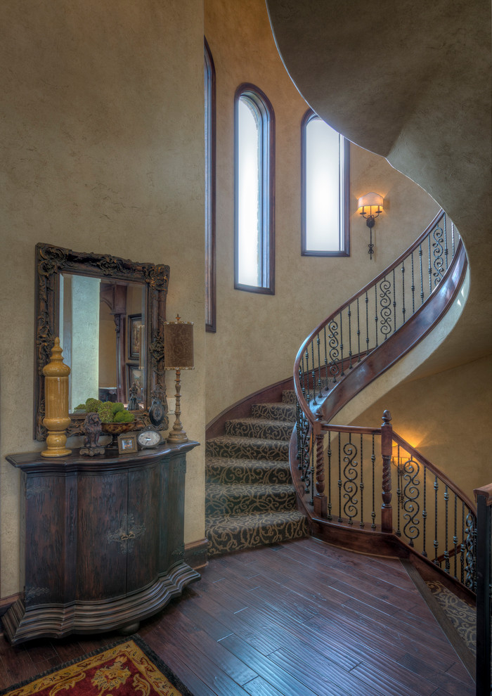 This is an example of a mediterranean staircase in Dallas with feature lighting.