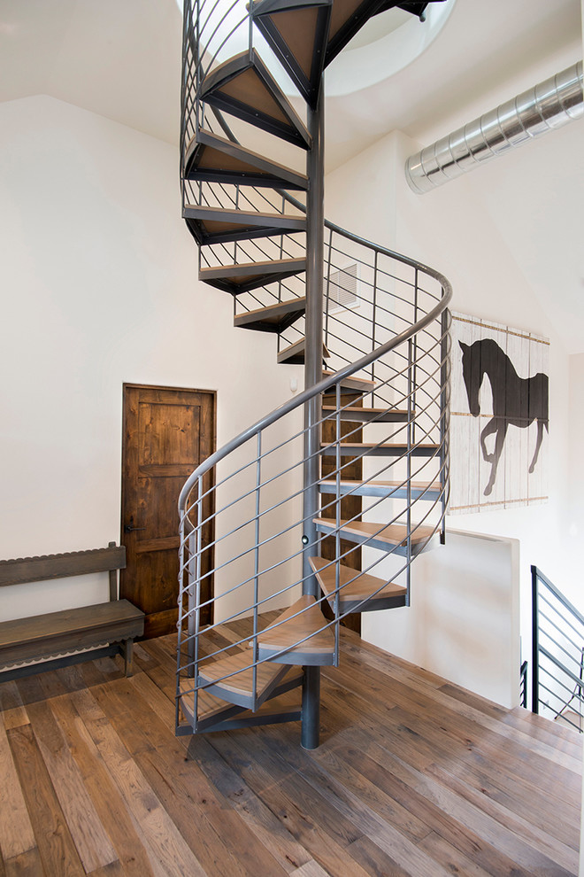 Photo of a medium sized contemporary wood spiral staircase in Albuquerque with open risers.