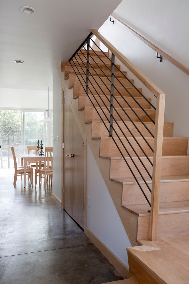Trendy wooden l-shaped staircase photo in Portland Maine with wooden risers