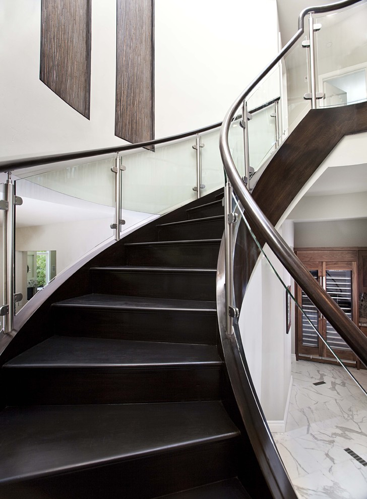 Trendy wooden curved staircase photo in San Francisco with wooden risers