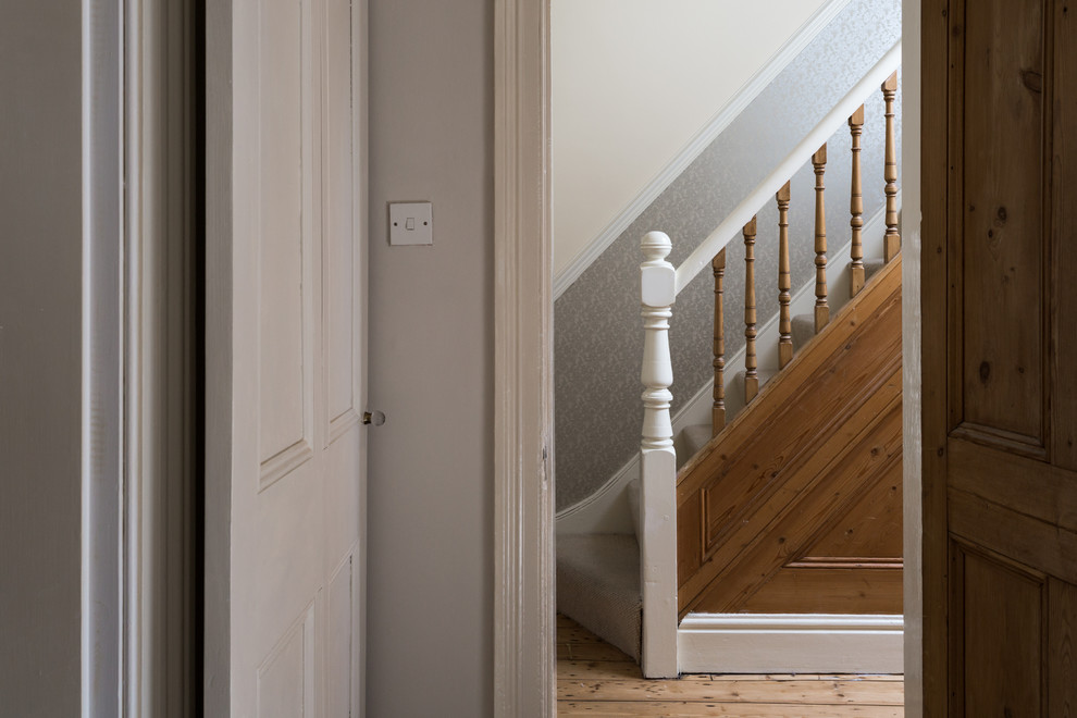 Design ideas for a small traditional carpeted straight staircase in Other with carpeted risers.