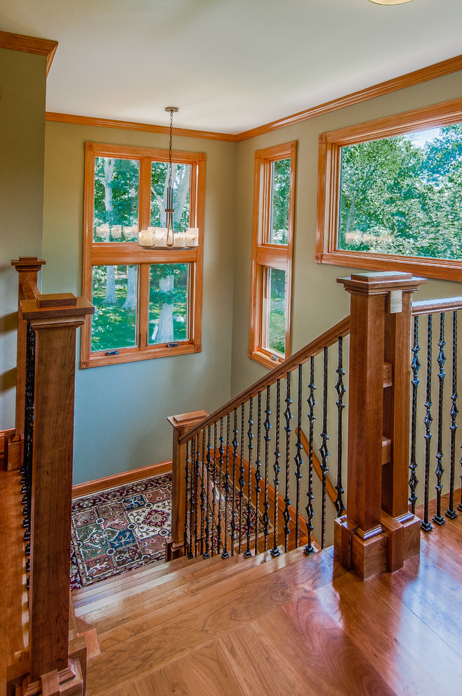 Medium sized traditional wood u-shaped staircase in DC Metro with wood risers.