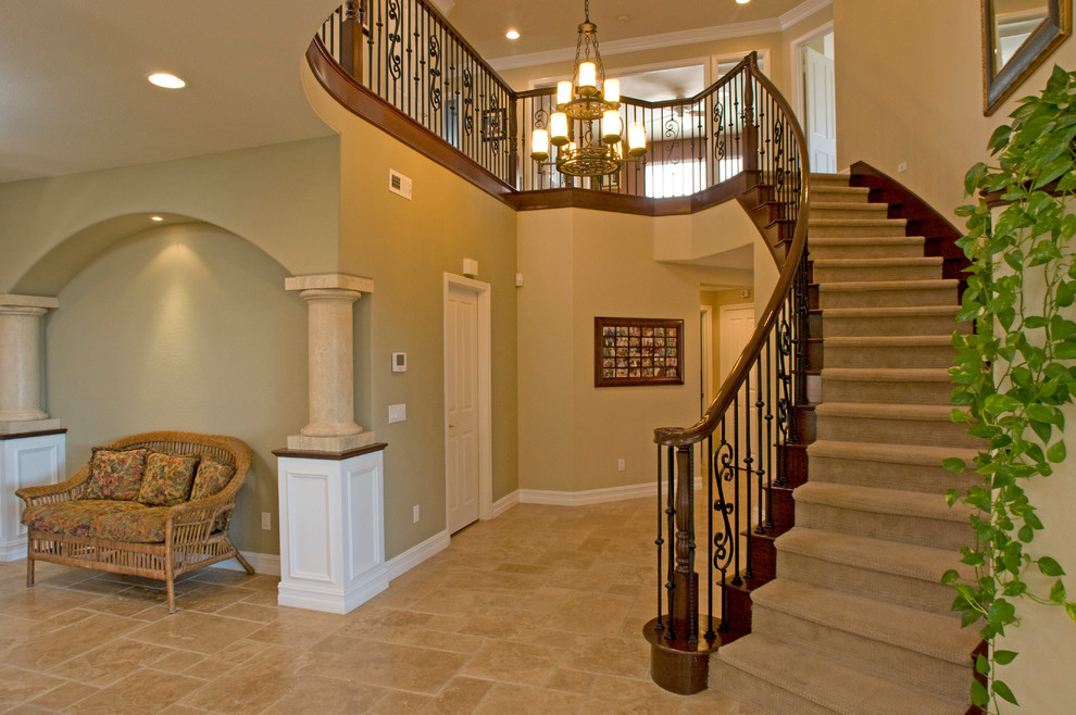 This is an example of a medium sized mediterranean carpeted curved staircase in San Diego with wood risers.