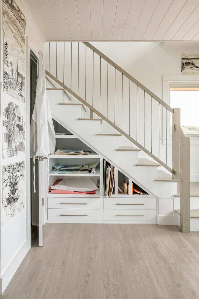 Design ideas for a beach style wood l-shaped mixed railing staircase in Portland Maine with painted wood risers and under stair storage.