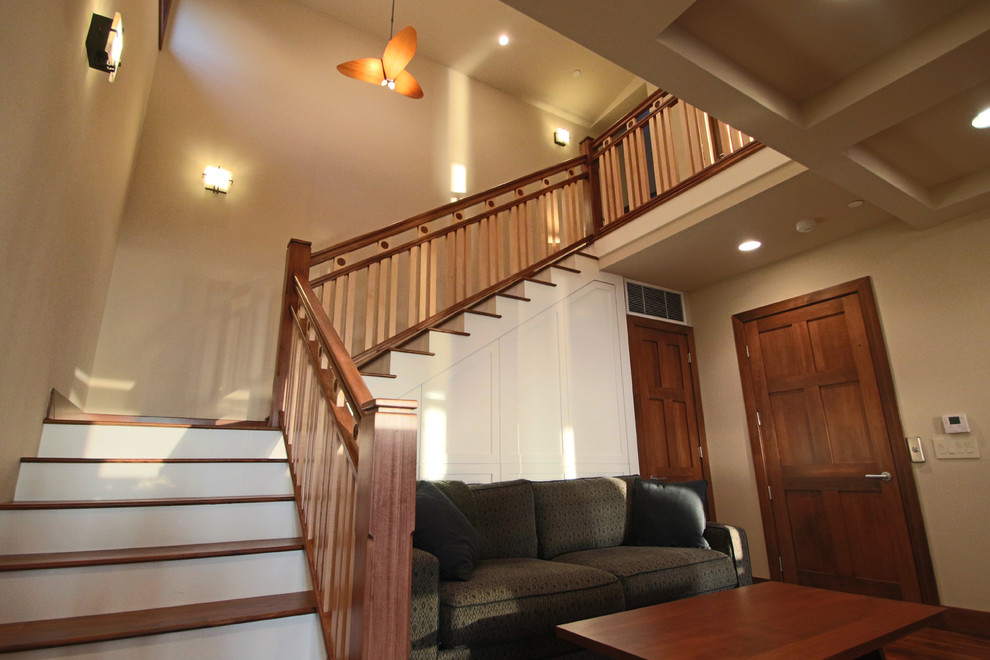 This is an example of a medium sized contemporary wood l-shaped staircase in Orange County with painted wood risers.