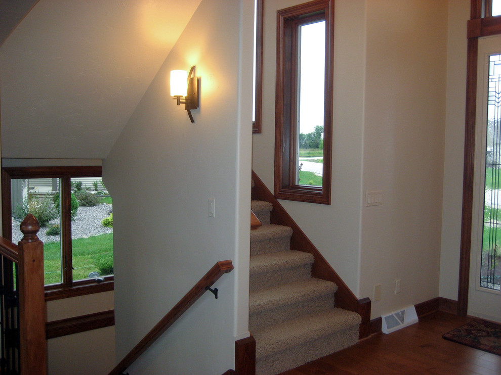 Example of a classic carpeted staircase design in Milwaukee with carpeted risers