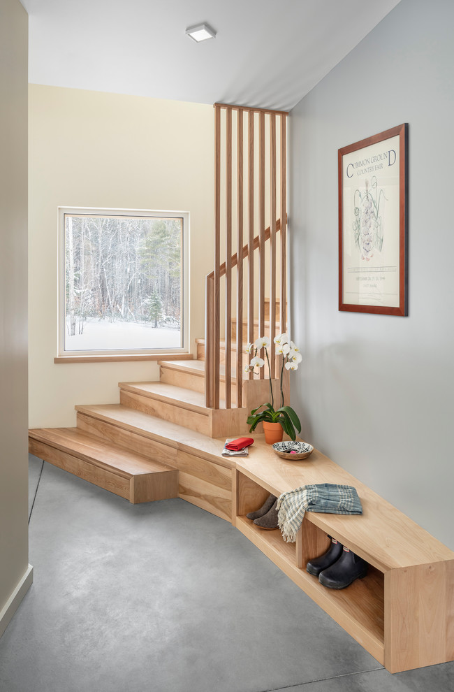 Photo of a small contemporary wood curved wood railing staircase in Portland Maine with wood risers and feature lighting.