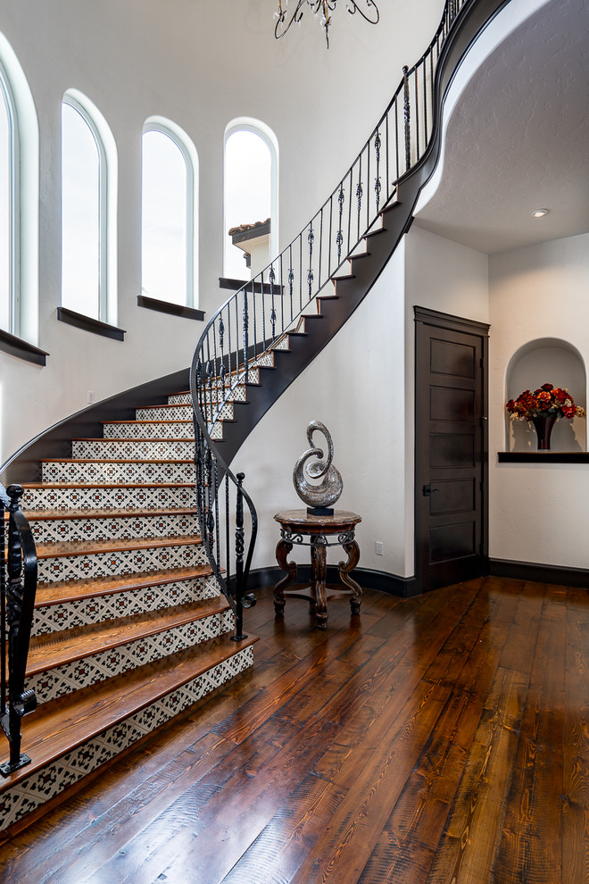 Wood curved metal railing staircase in Seattle with tiled risers.