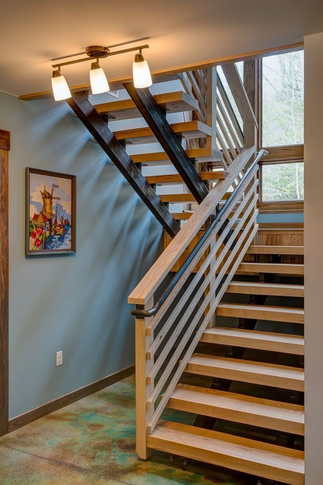 他の地域にあるお手頃価格の中くらいなコンテンポラリースタイルのおしゃれな階段 (木材の手すり) の写真