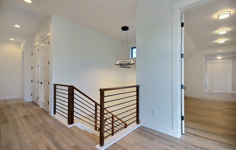 Large cottage wooden u-shaped mixed material railing staircase photo in Portland with painted risers