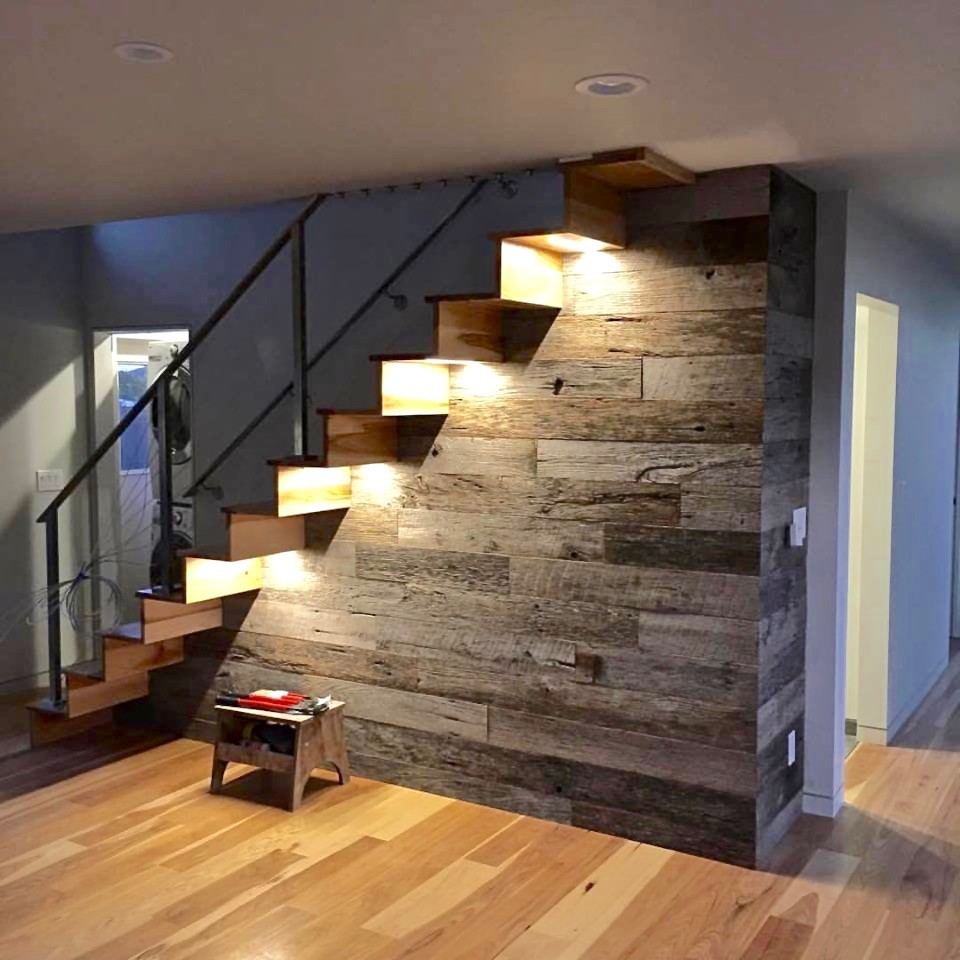 Medium sized midcentury wood floating staircase in San Francisco with wood risers.