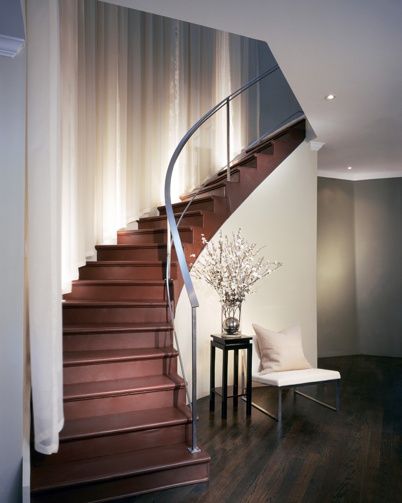 Photo of a medium sized contemporary wood curved staircase in Denver with wood risers.