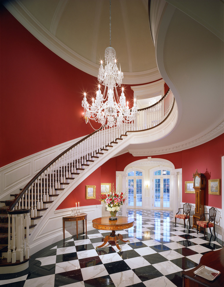 Photo of an expansive traditional curved staircase in Los Angeles.