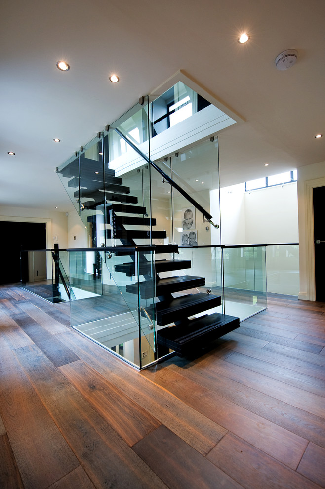 Contemporary floating staircase in Other with open risers.