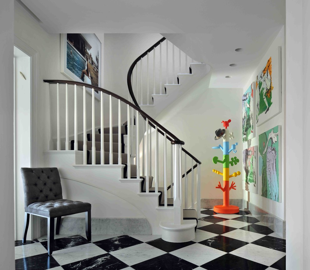 Large contemporary painted wood curved staircase in London with painted wood risers.