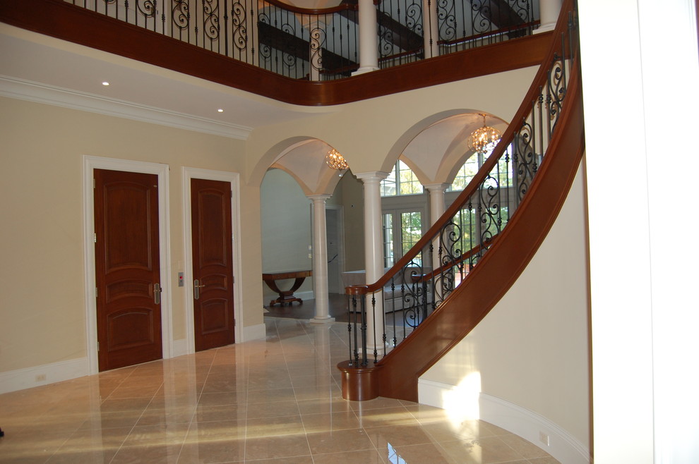 Design ideas for an expansive mediterranean tiled curved staircase in Boston with tiled risers.