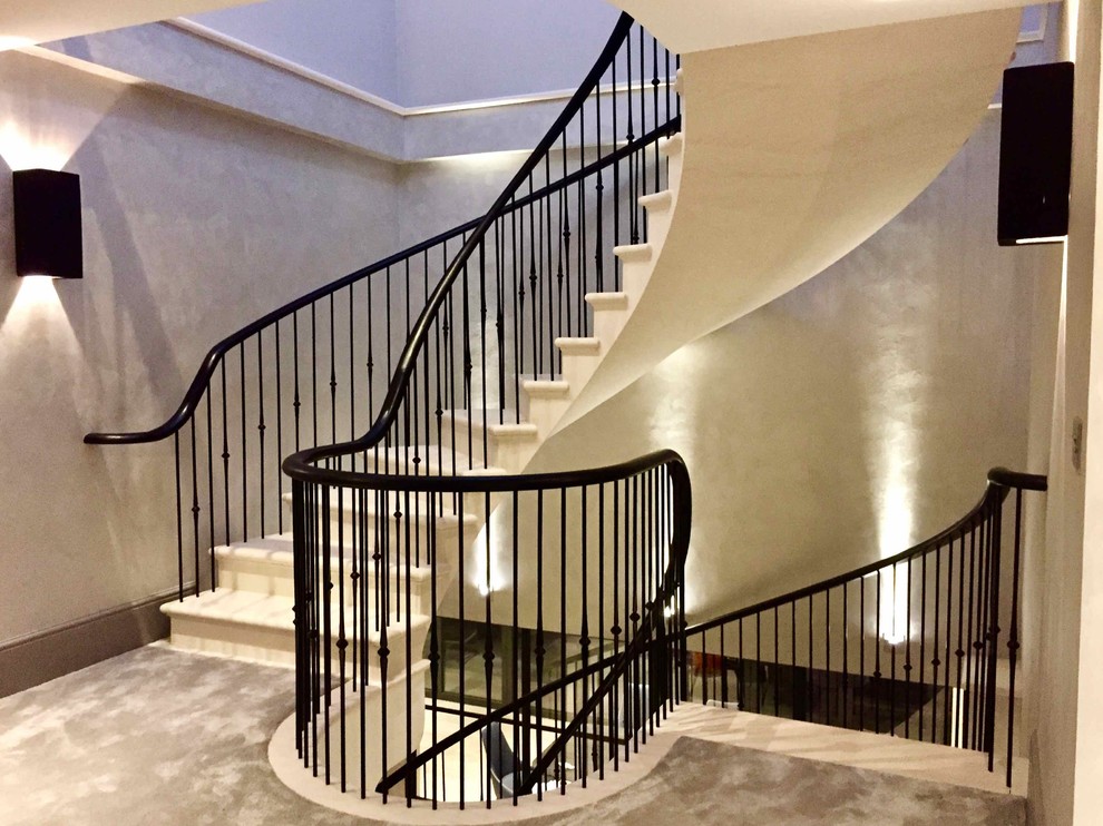 Diseño de escalera curva actual de tamaño medio con escalones de piedra caliza y contrahuellas de piedra caliza