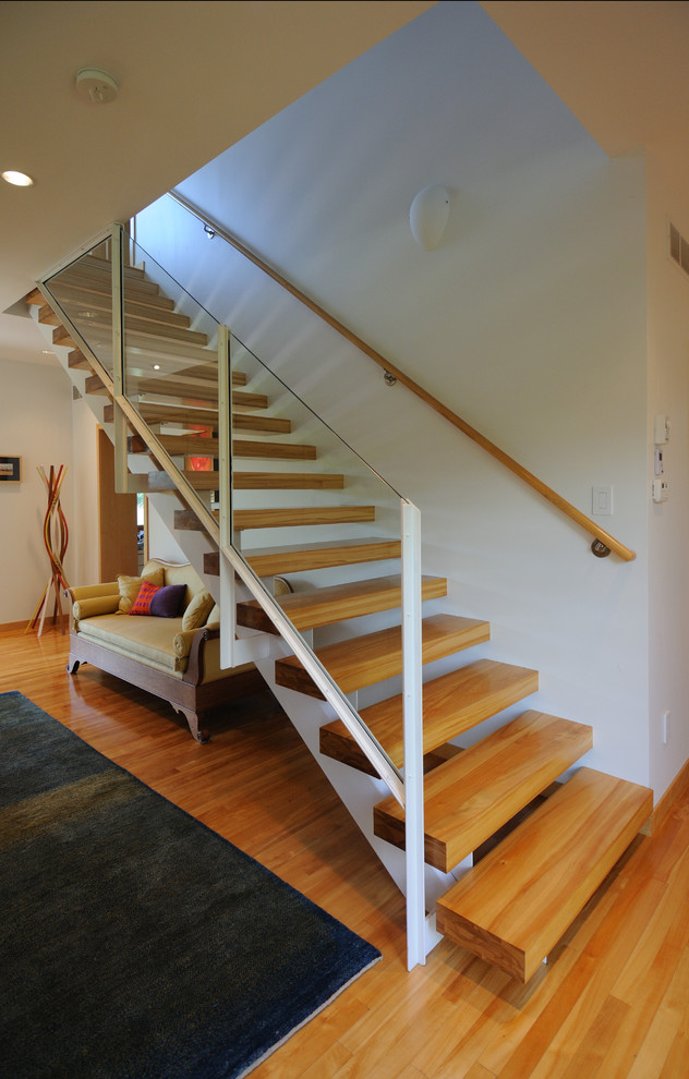 This is an example of a contemporary wood staircase in Minneapolis with open risers.