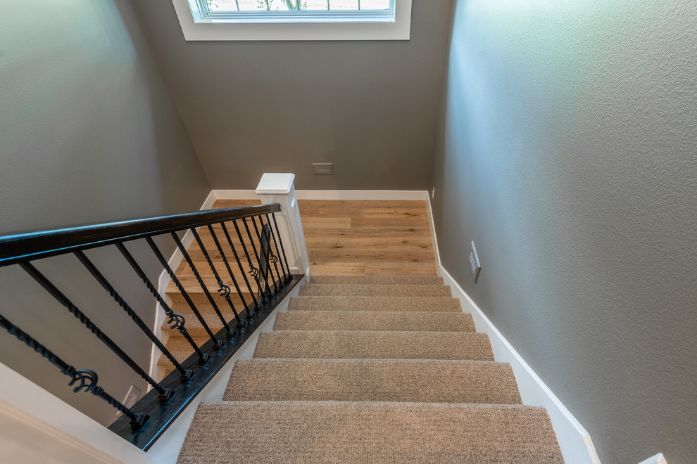 Design ideas for a farmhouse carpeted u-shaped metal railing staircase in Other with carpeted risers.