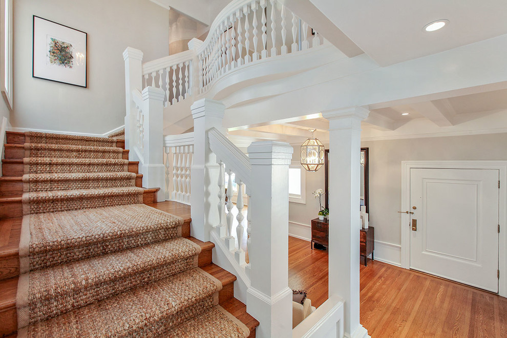 Example of a huge transitional carpeted l-shaped wood railing staircase design in San Francisco with carpeted risers