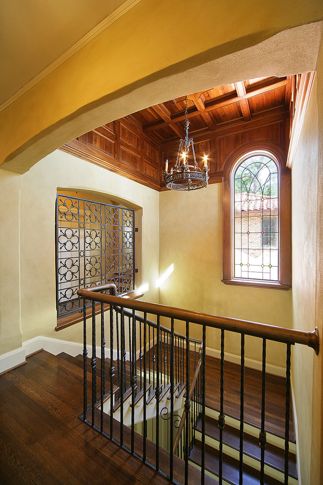 This is an example of a mediterranean wood u-shaped staircase in Dallas.