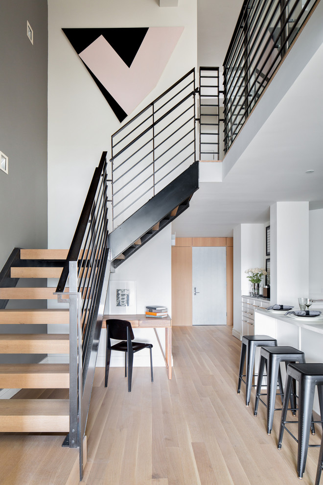 Scandinavian wood l-shaped staircase in New York with open risers.