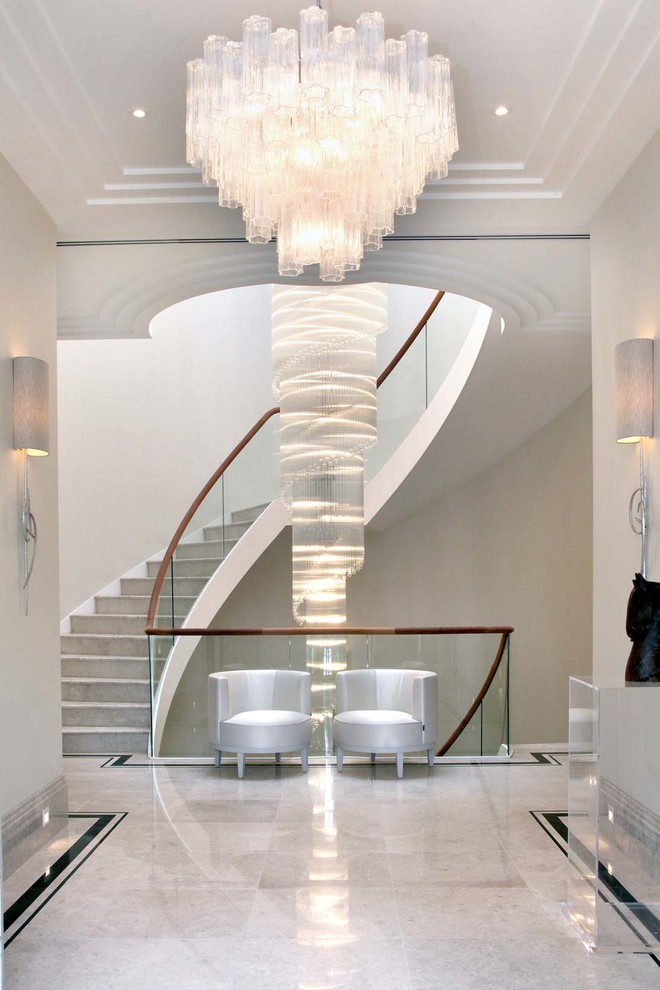 Design ideas for a contemporary concrete curved staircase in London with concrete risers and feature lighting.