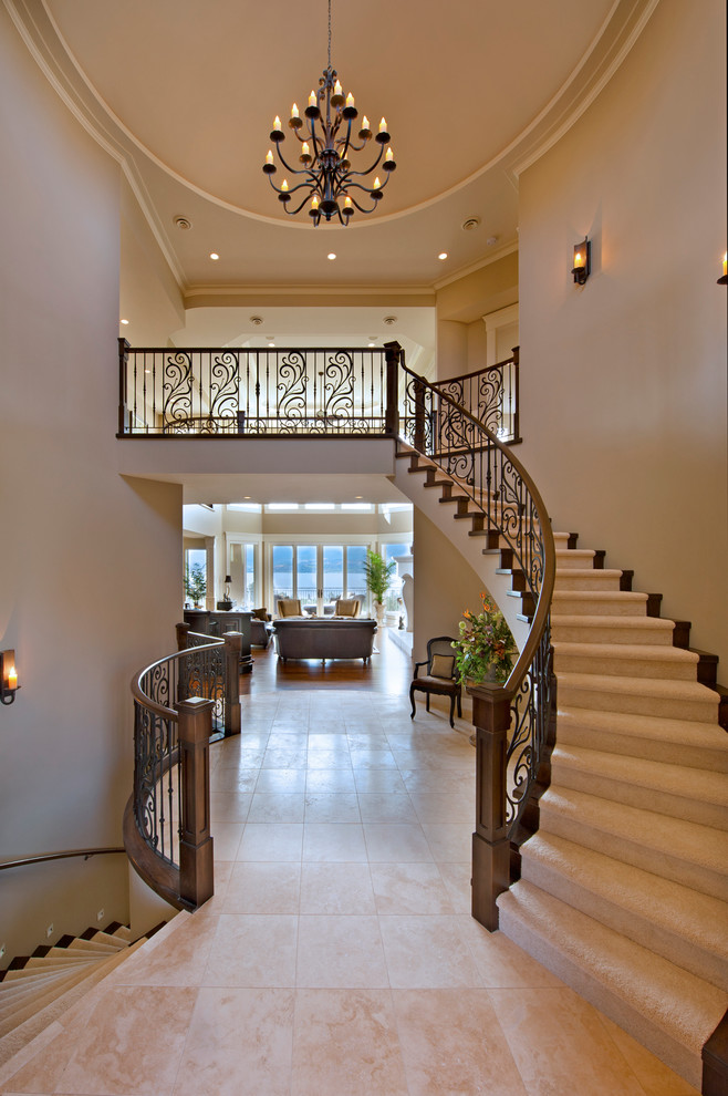 Tuscan wooden curved staircase photo in Vancouver with wooden risers