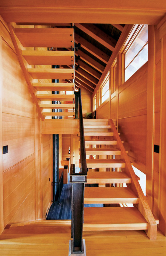 Foto de escalera en U contemporánea de tamaño medio sin contrahuella con escalones de madera y barandilla de metal