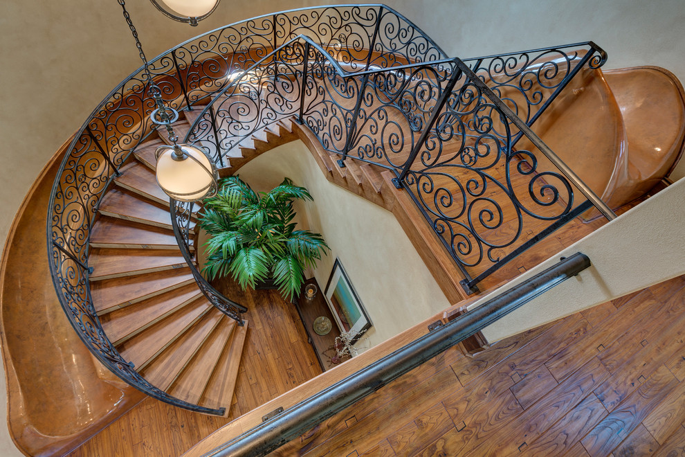Inspiration for a mediterranean wood spiral staircase in Orlando with wood risers.