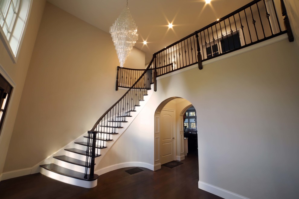 Staircase - large mediterranean wooden spiral staircase idea in Boston with painted risers