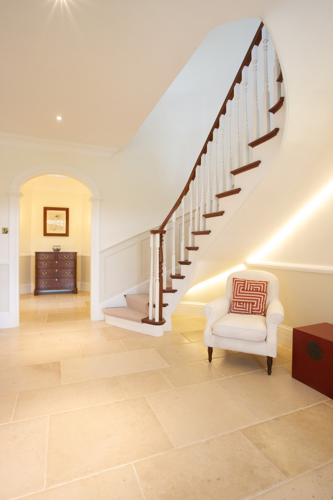 Traditional carpeted curved staircase in Wiltshire with carpeted risers and a dado rail.