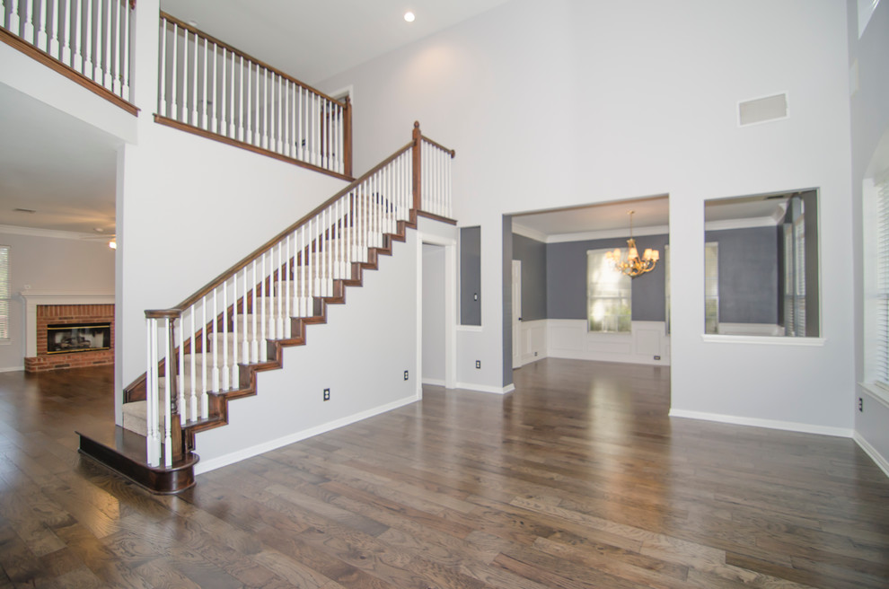 Inspiration for a mid-sized transitional carpeted straight wood railing staircase remodel in Austin with carpeted risers