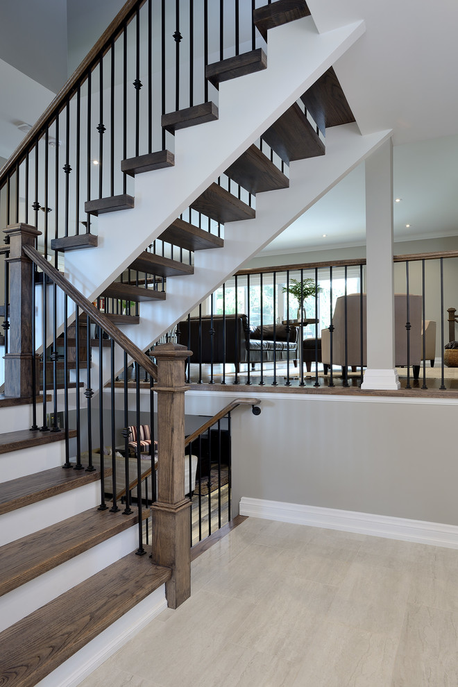 Inspiration for a mid-sized timeless wooden l-shaped metal railing staircase remodel in Toronto with painted risers