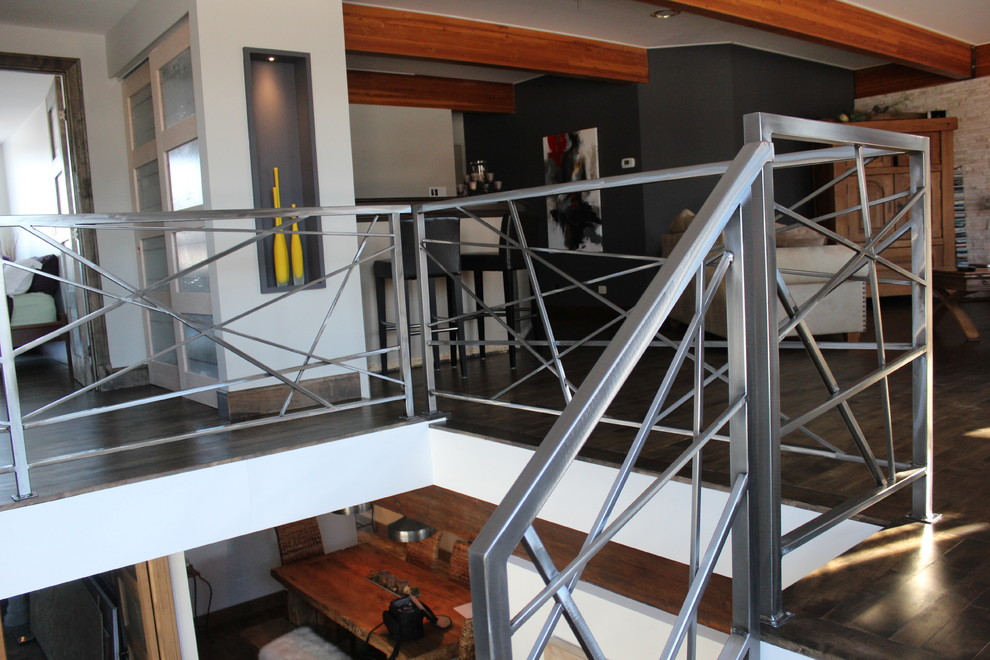 This is an example of a contemporary wood staircase in Montreal with open risers.