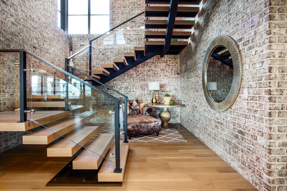 Inspiration for an industrial wood floating glass railing staircase in Salt Lake City with open risers.