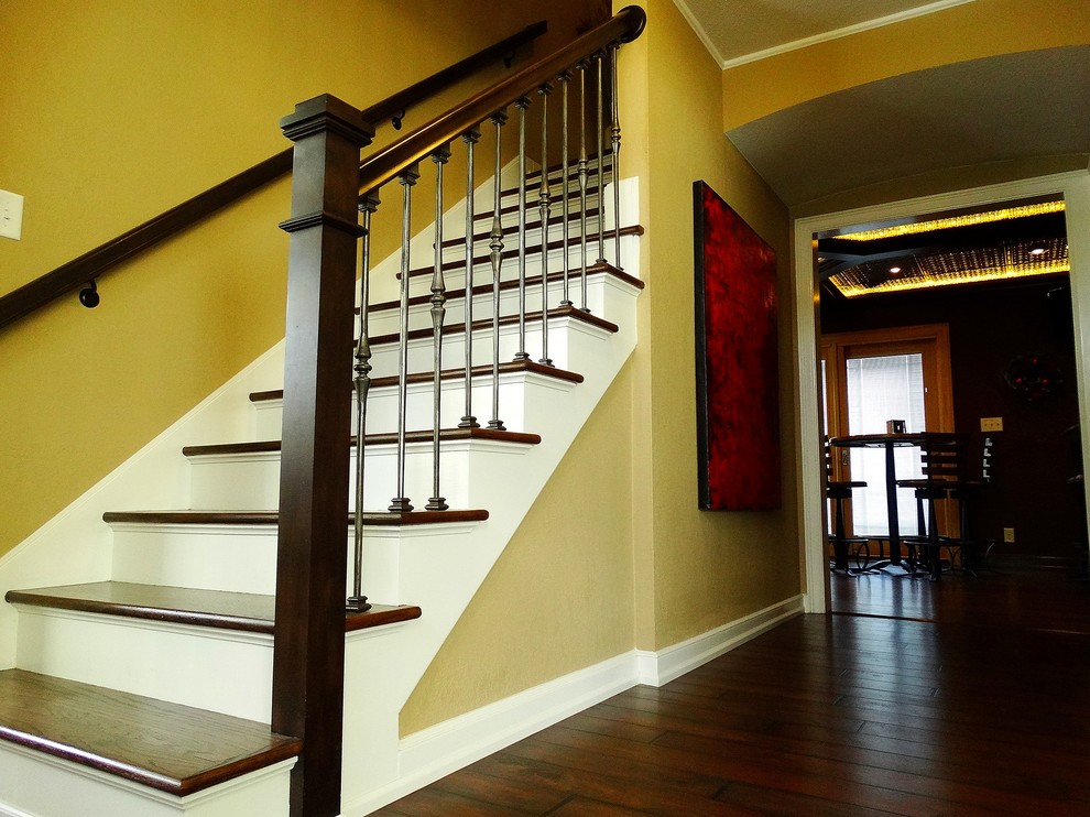 Inspiration for a mid-sized timeless wooden straight staircase remodel in Milwaukee with painted risers